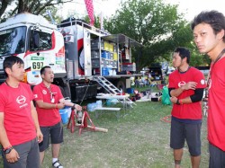 Team mechanics are preparing for the trucks’ arrival.