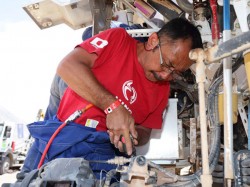 Mechanic leader Seiichi Suzuki adjusts a shock absorber mount. 
