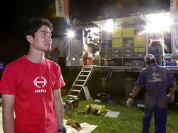 Hiroyuki Sugiura looks on as mechanics service the truck. 
