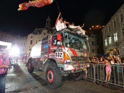 Hino team mechanics ride on the truck's roof to celebrate the goal ceremony. 