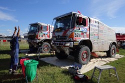 A mechanic signals to Car 1 as it arrives at the bivouac. 