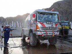 Mechanics wash down Car 1.